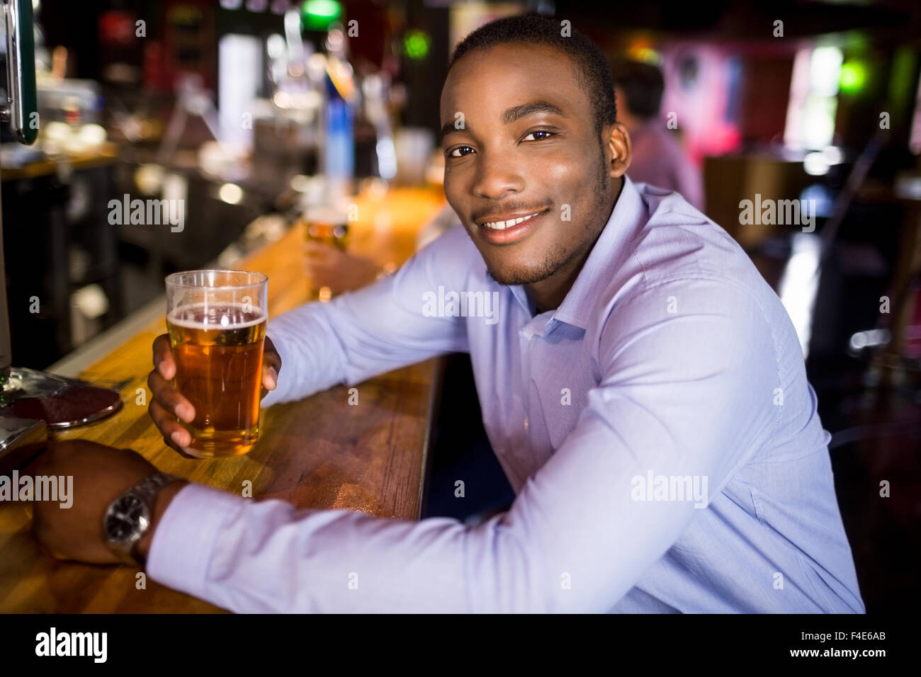 Smiling businessman having a drink Stock Photo