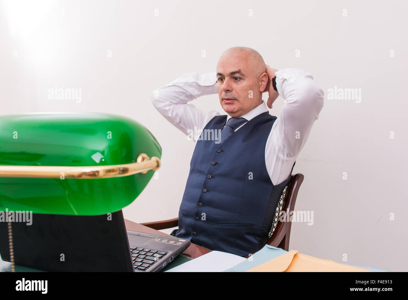 business man at desk, deep in thought, staring off into space, concentrated on his thoughts. Stock Photo