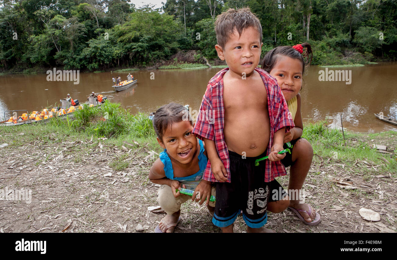 Girls hiding behind little boy, Amazon basin, Peru Stock Photo - Alamy