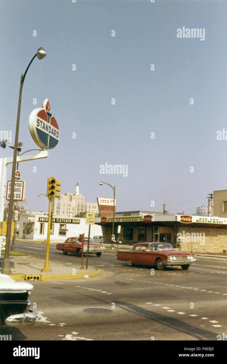 traveling by train around the United States in the early 1960s. travel. Standard Oil gas station and diner with car at the intersection of Meridian and 16th Street in Indianapolis 1963. street scene Stock Photo
