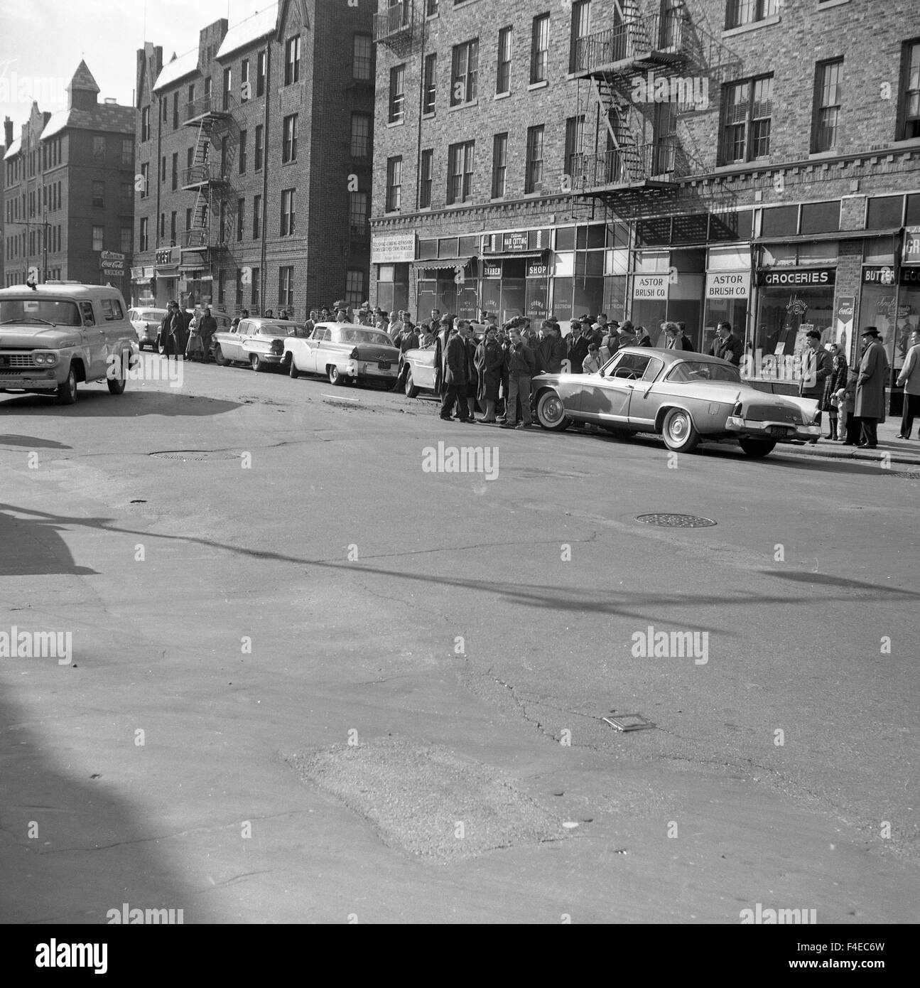 bystanders watching at scene - 1950s cars men wearing hats Stock Photo