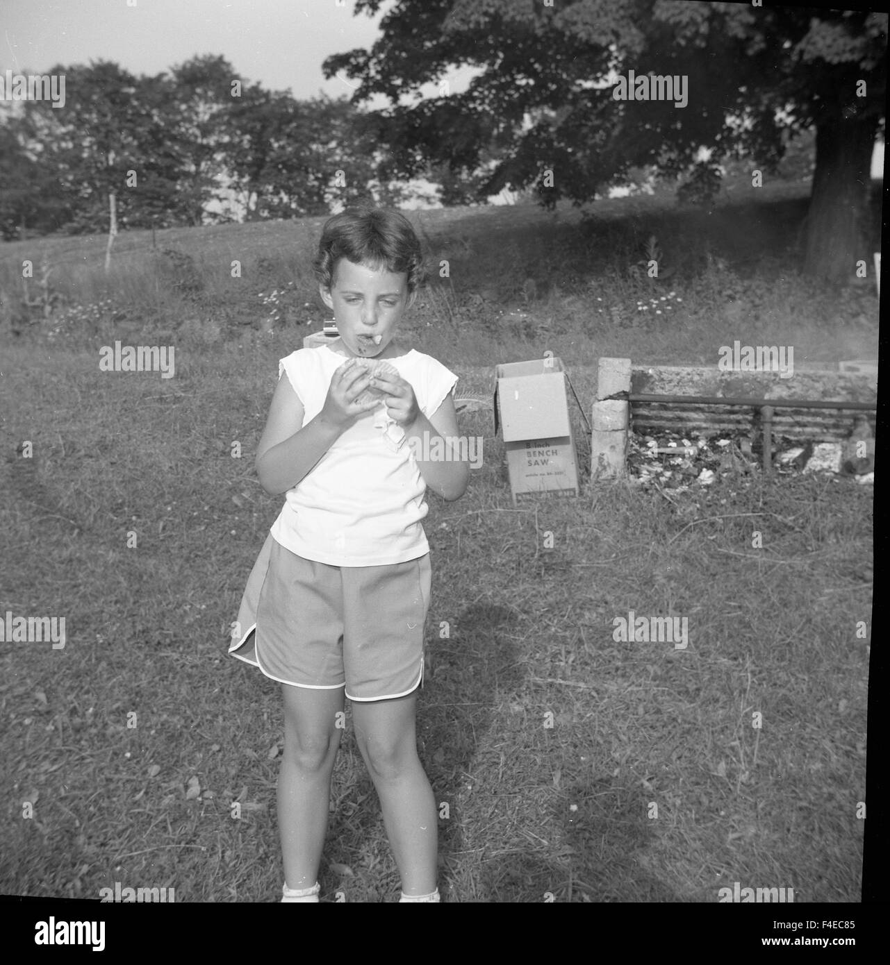 little girl eating watermelon during a summer picnic Stock Photo