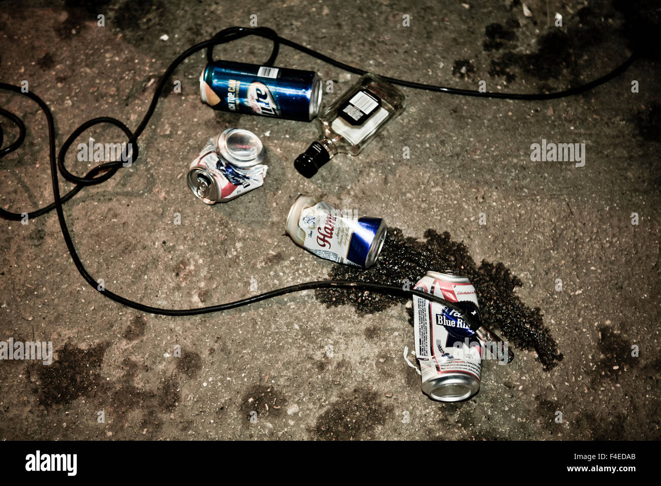Crushed empty beer cans on concrete floor after basement for punk rock