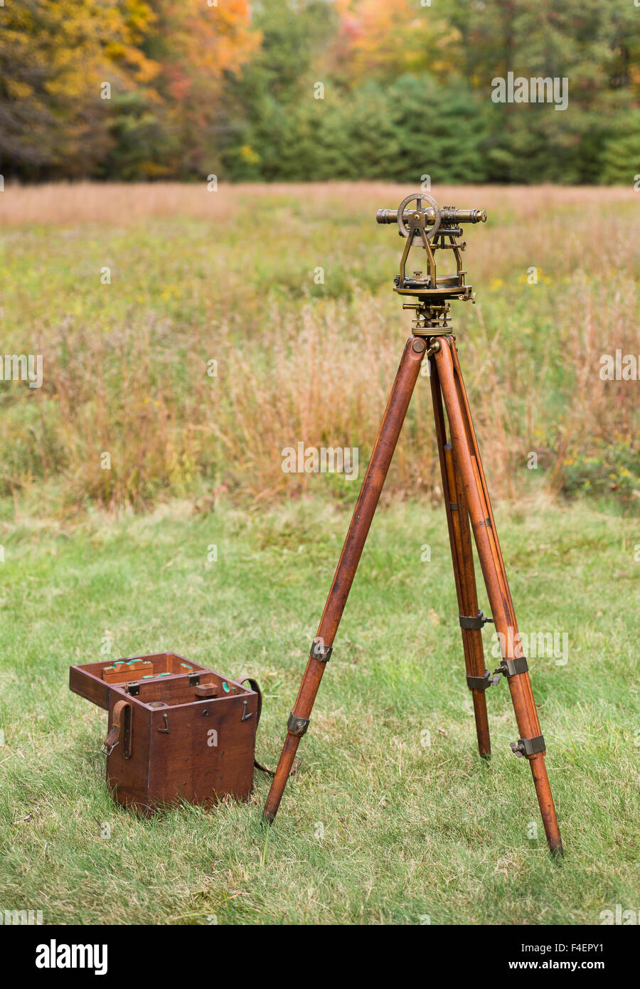 Vintage Brass Surveying Level (Transit, Theodolite) with Compass and aged Brass Patina, on a  wooden Tripod with Storage Case Stock Photo
