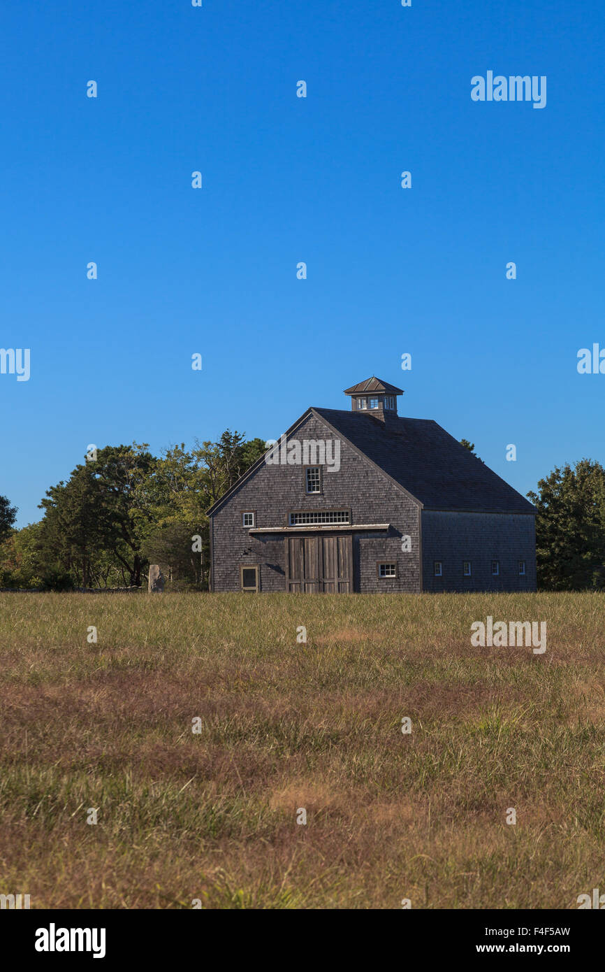 New England rustic barn in summer with a green grass lawn Stock Photo