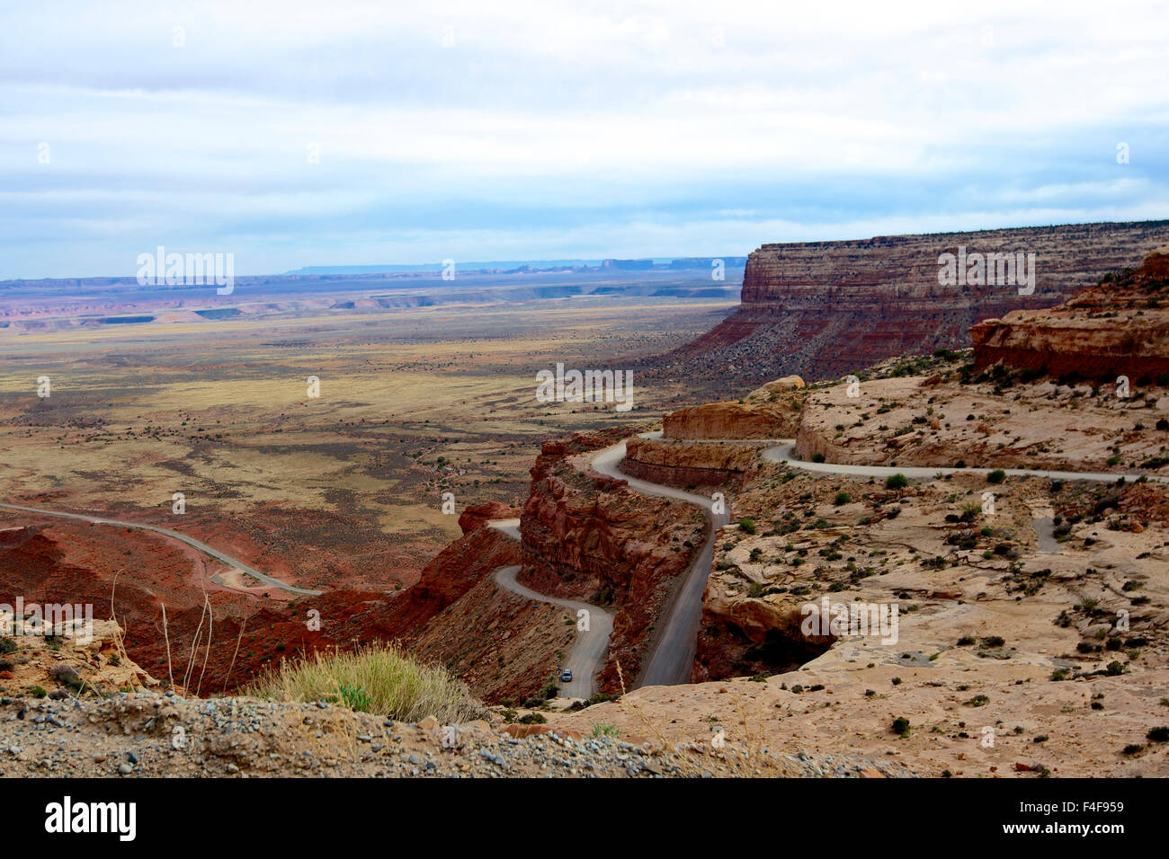 Route 261, the Moki Dugway steeply drops 1200 feet in 3 miles of gravel road, dropping off to the San Juan River valley. A few pullouts offer stunning views over the desert basin and the Valley of the Gods. Stock Photo