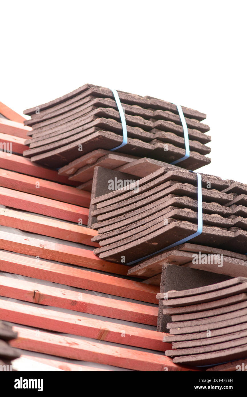 Stacks of roof tiles on roof ready for fitting to Victorian style home