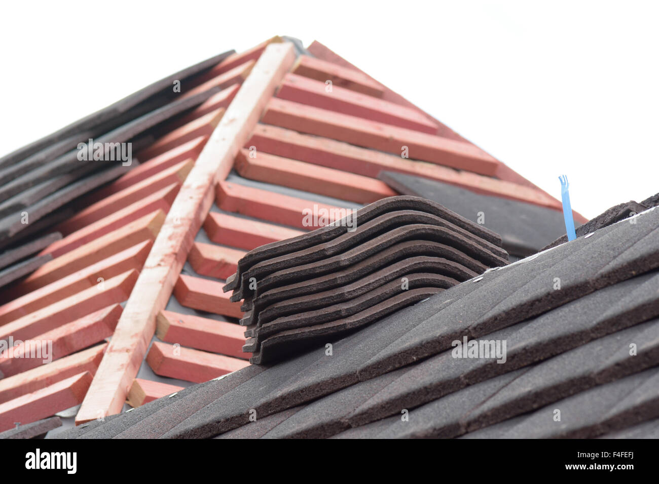 Stacks of roof tiles on roof ready for fitting to Victorian style home
