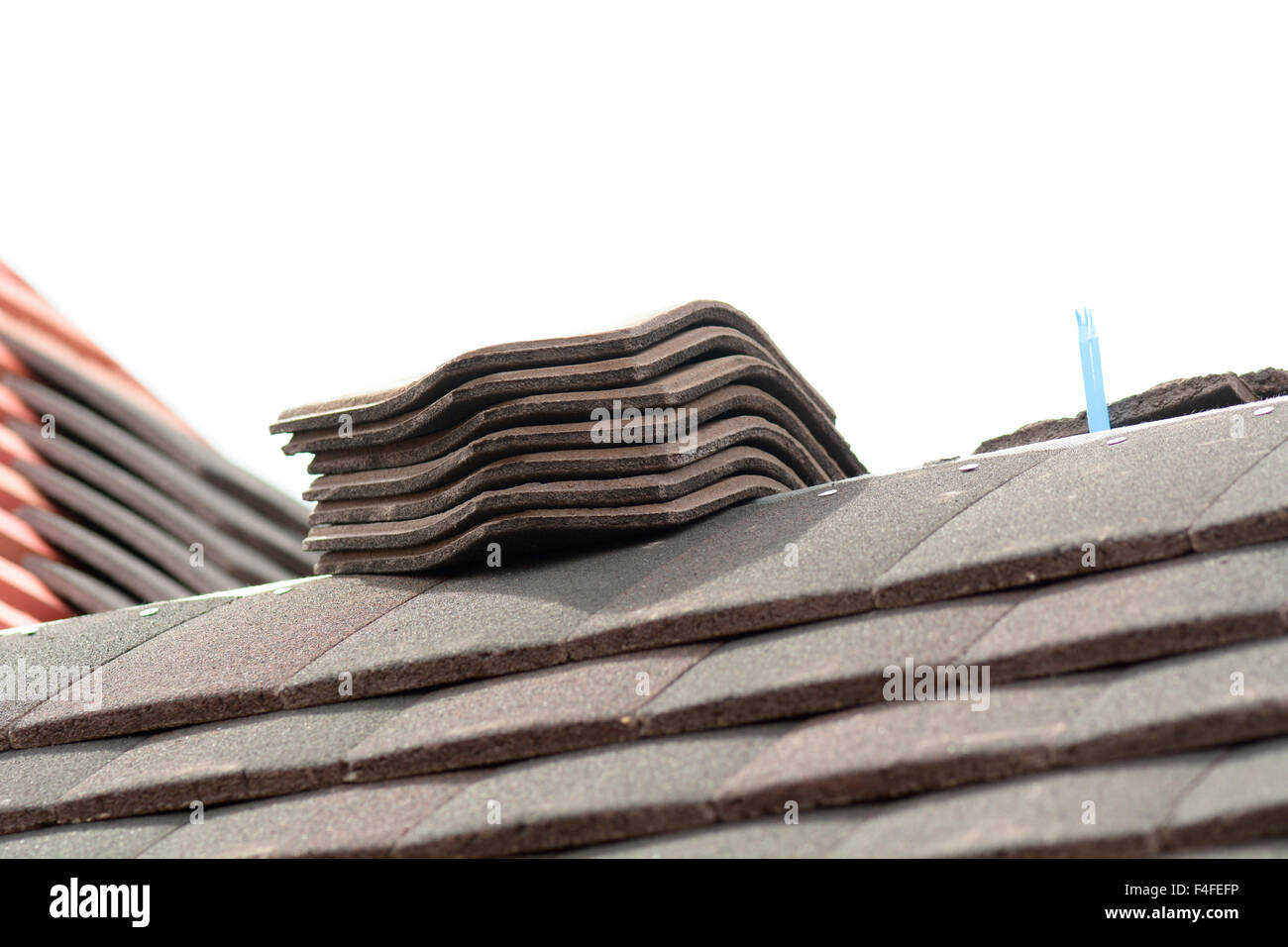 Stacks of roof tiles on roof ready for fitting to Victorian style home