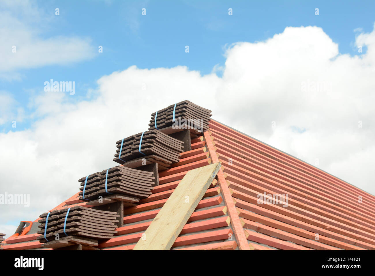 Stacks of roof tiles on roof ready for fitting on Victorian style