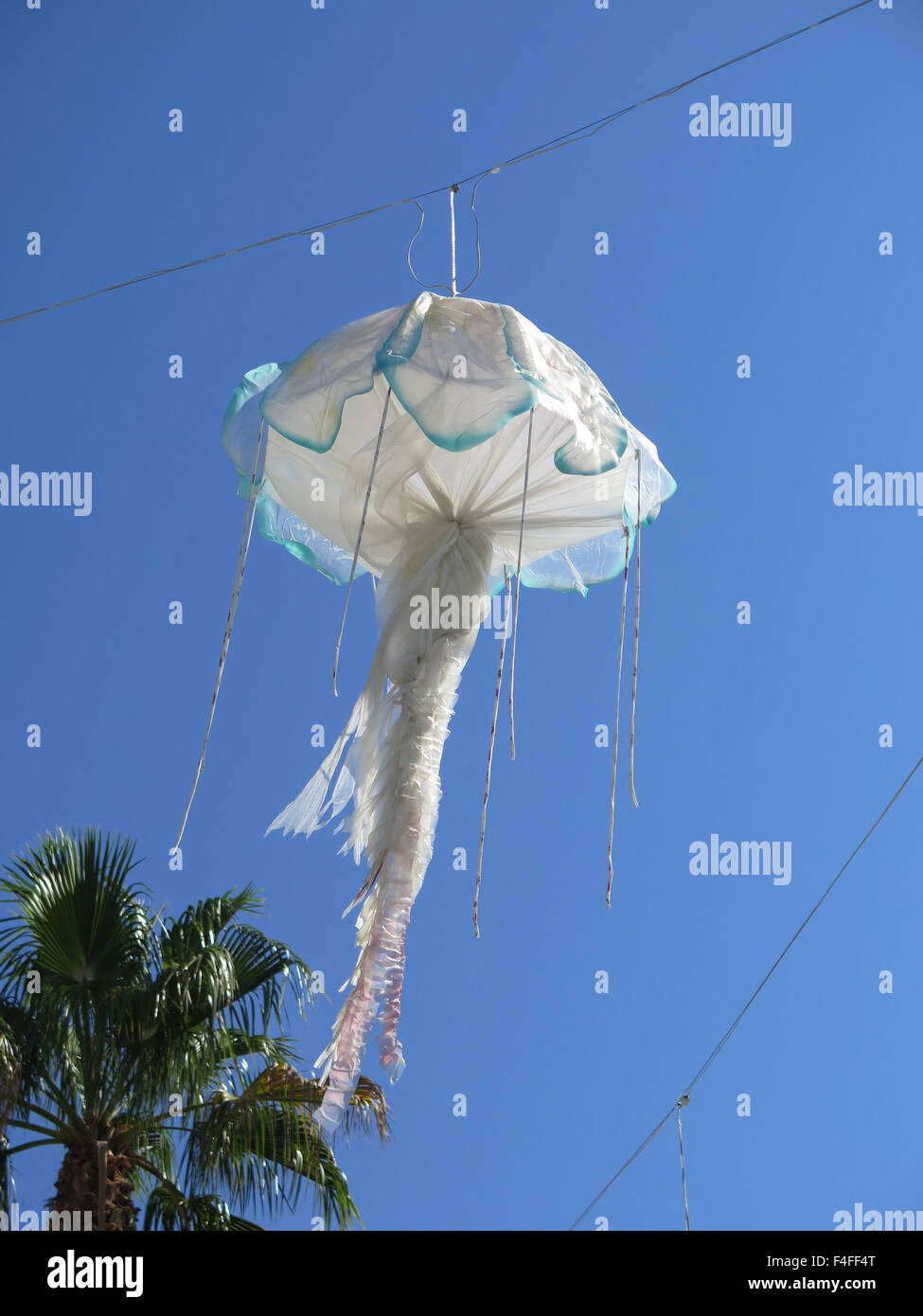 Large jellyfish shaped lanterns suspended on Malaga harbour quay Stock Photo