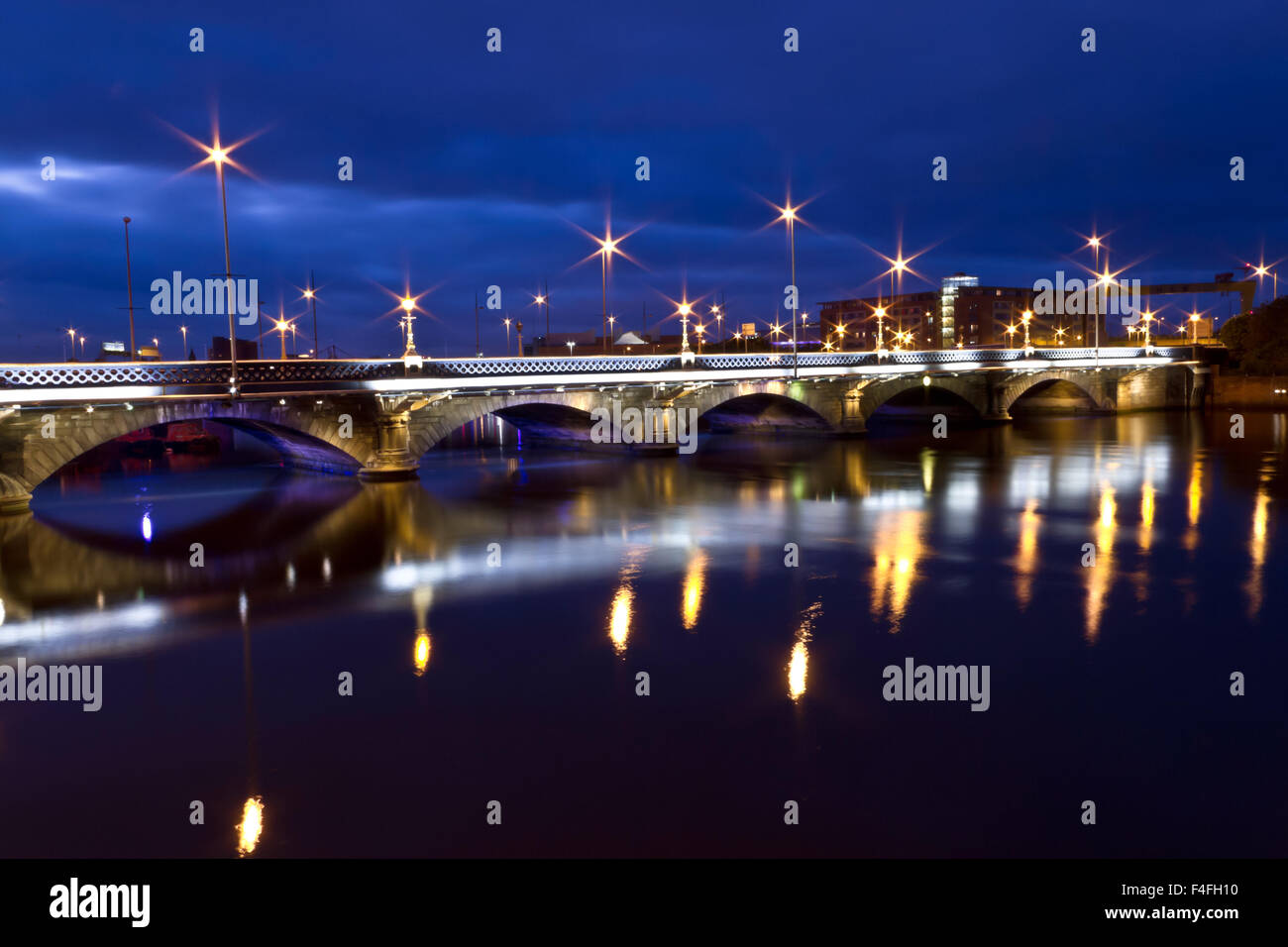 Queens Bridge, Belfast, Northern Ireland, UK, taken in the blue hour on a long exposure capturing the light reflections. Stock Photo
