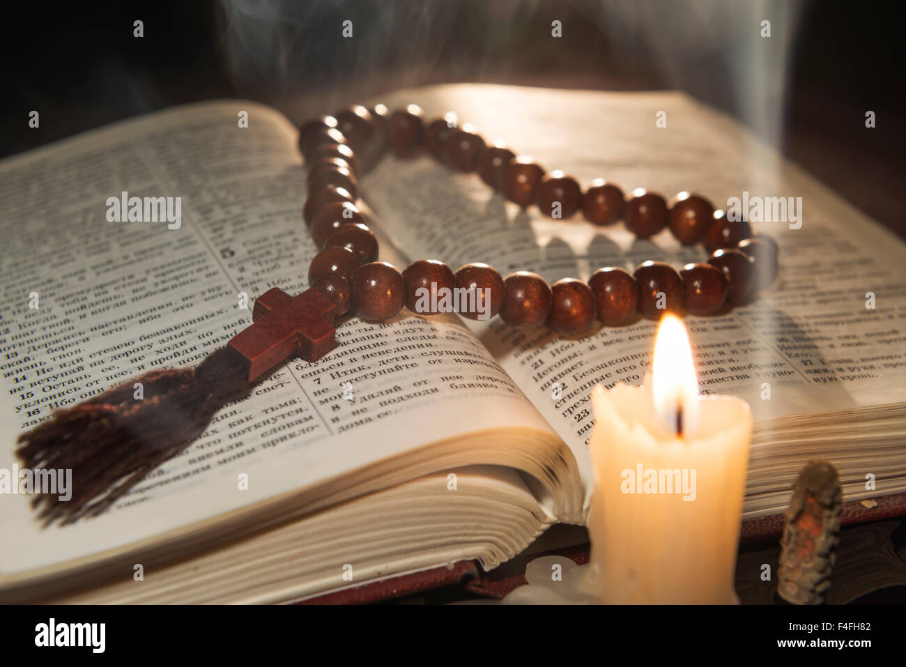 candle with incense and holy book Stock Photo