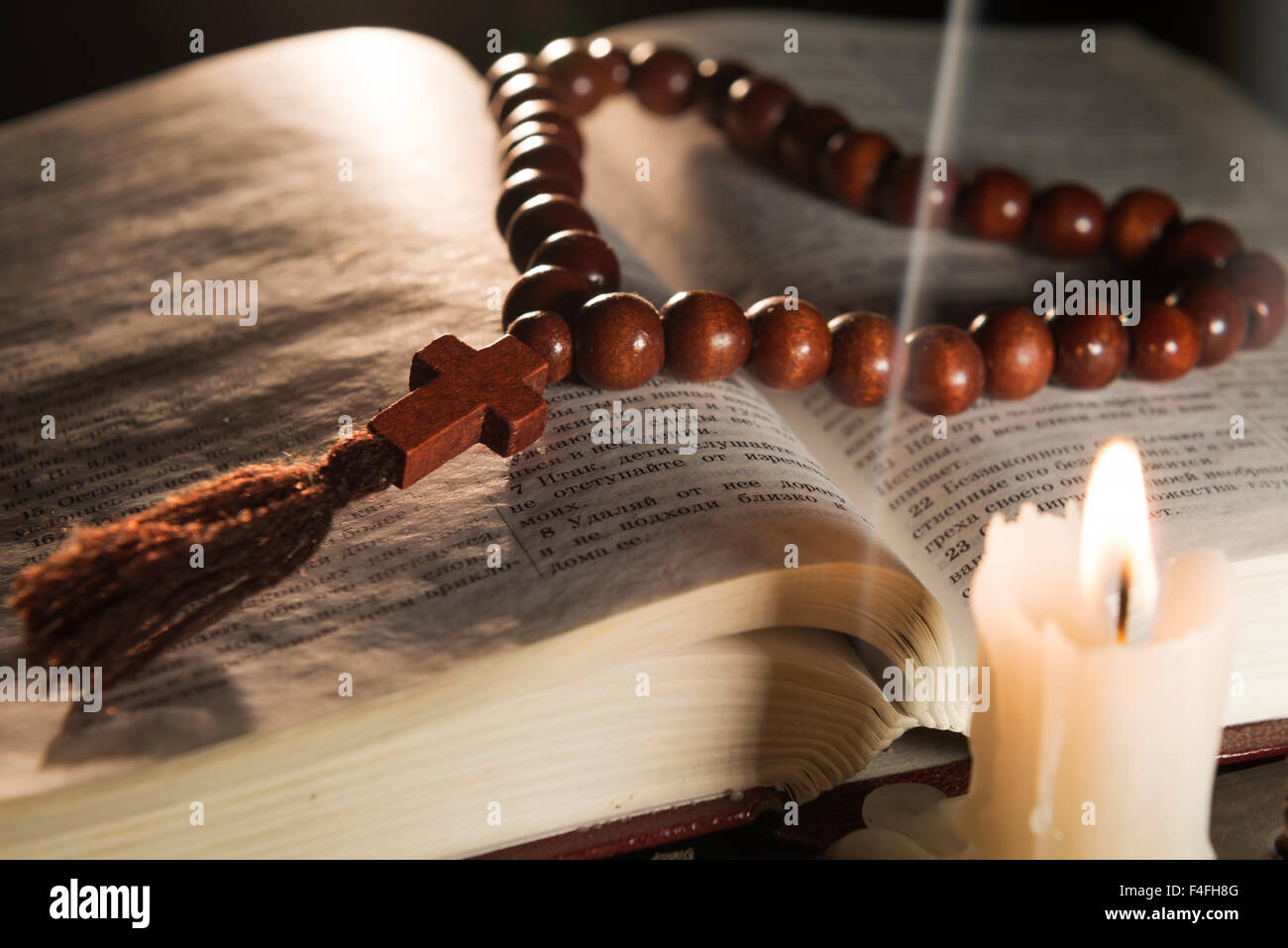 candle with incense and holy book Stock Photo