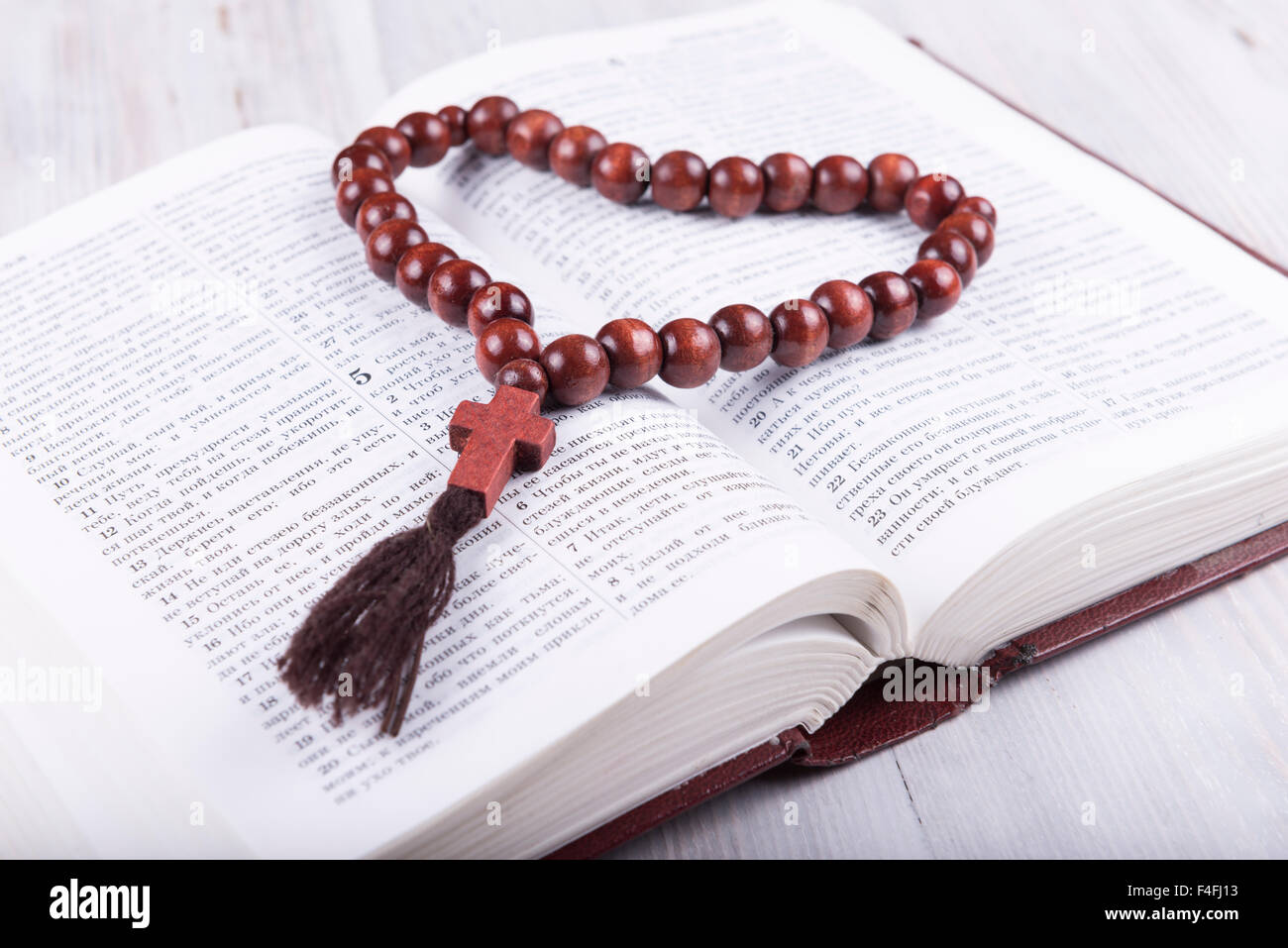 religious theme holy book and cross on a white wooden background Stock Photo