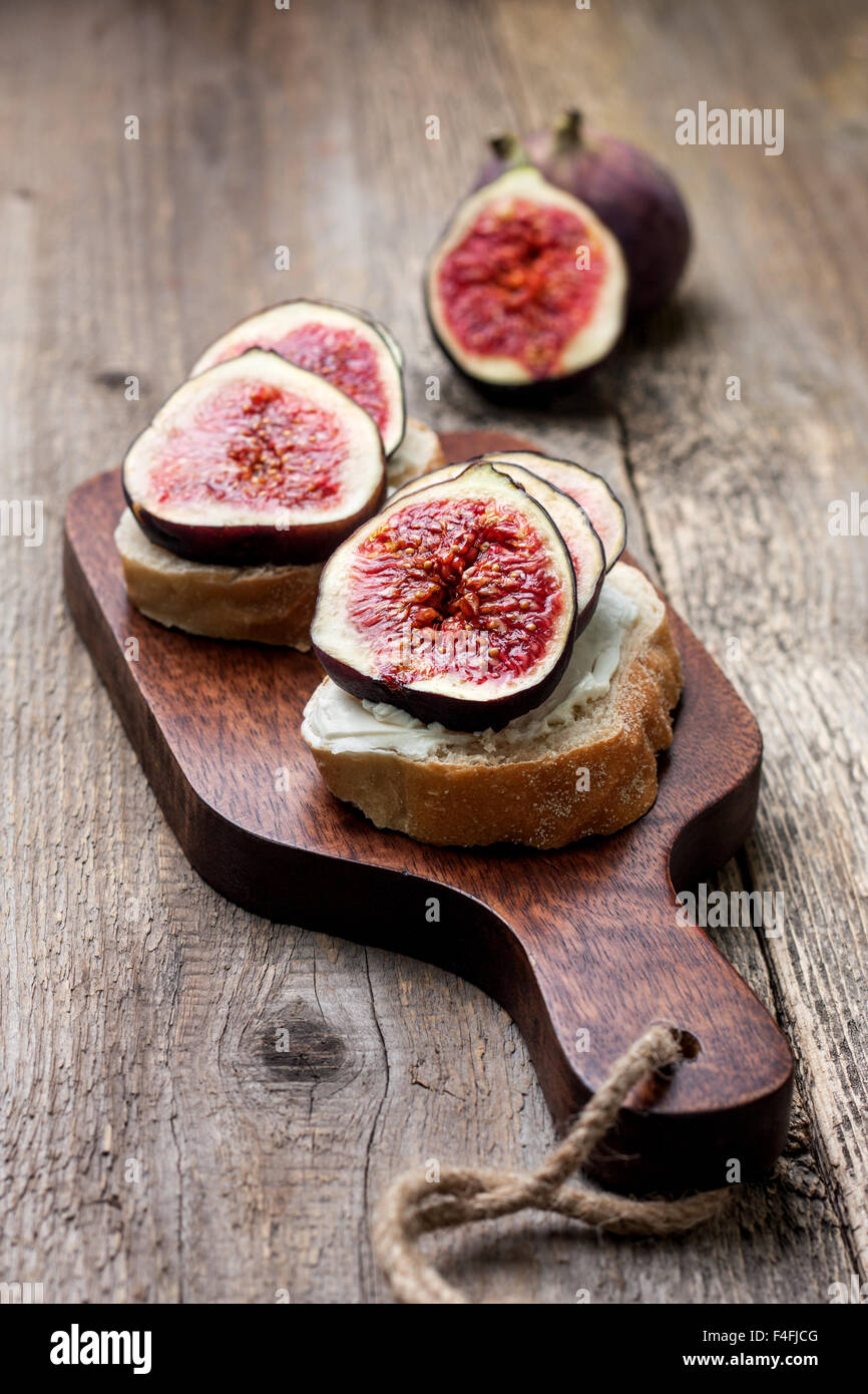 bread with figs, ricotta  on a cutting board Stock Photo