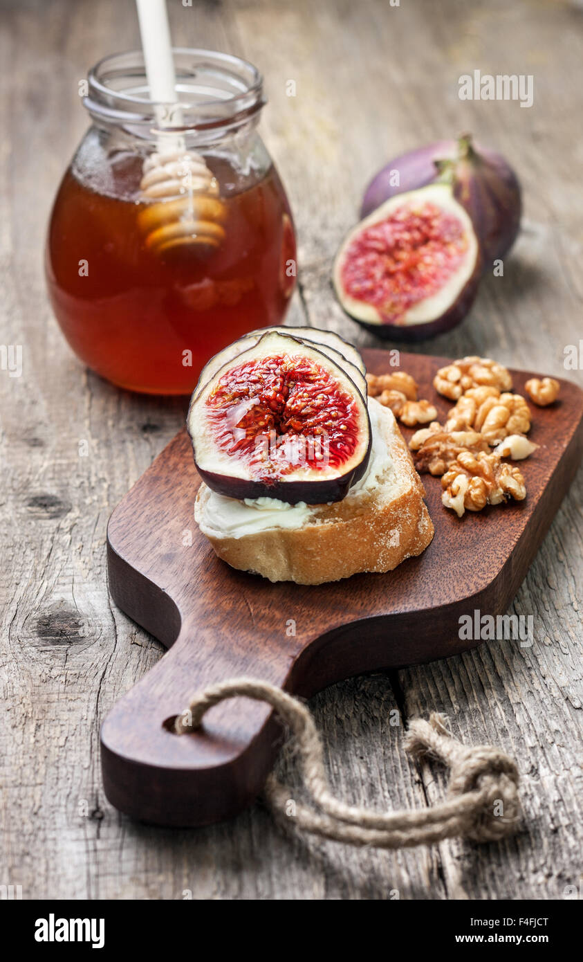 bread with figs, ricotta, honey on a cutting board Stock Photo Alamy