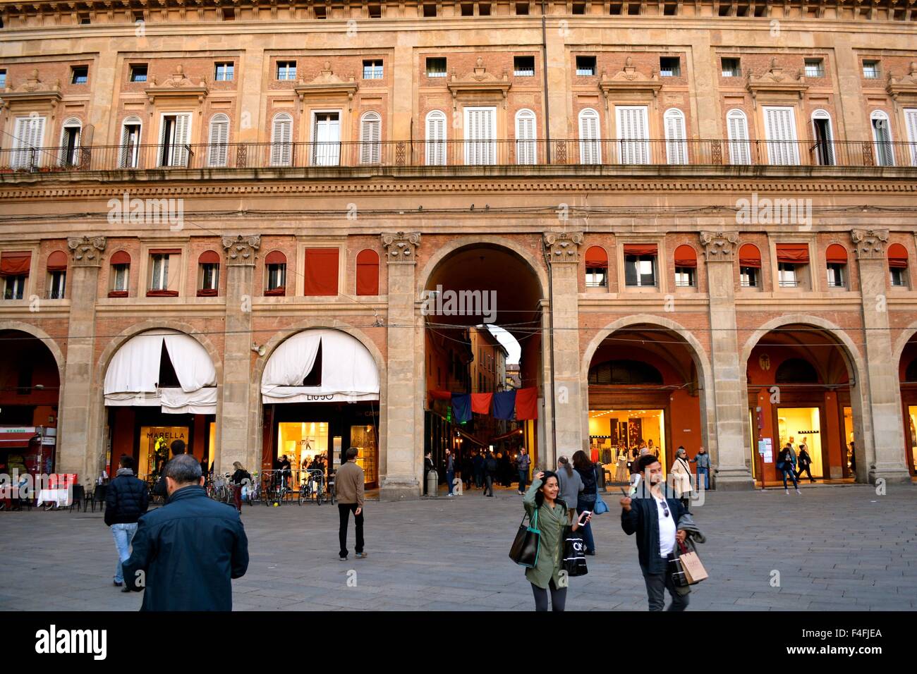 Shops lining the edge of Piazza Maggiore in Bologna Italy Stock Photo