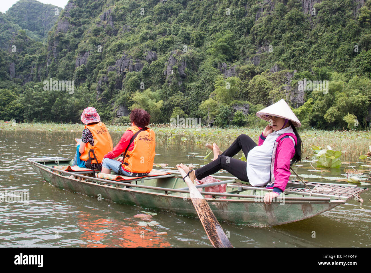 Pregnant Vietnamese Lady Rows With Her Feet Two Japanese Tourists In Lifejackets Along Ngo Dong