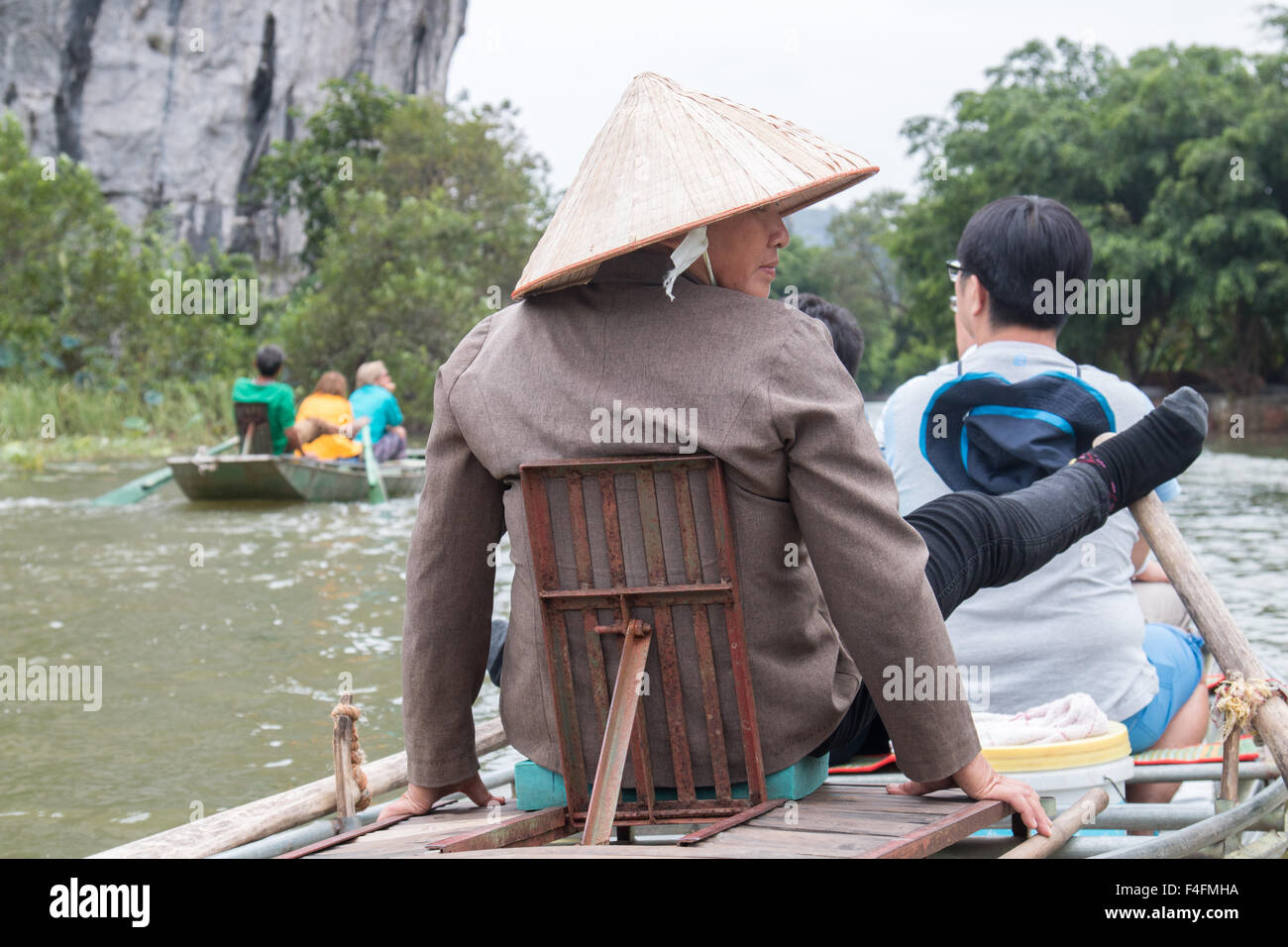 vietnames elady rows with her feet legs on ngo dong river,tam coc,vietnam Stock Photo