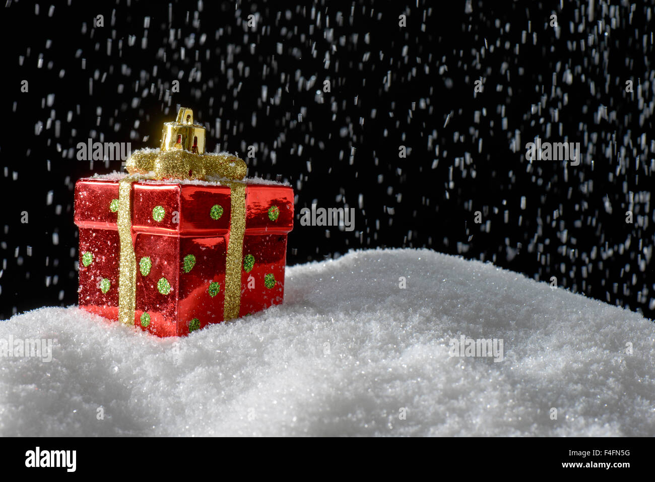 Christmas decoration Present on snow and its snowing Stock Photo