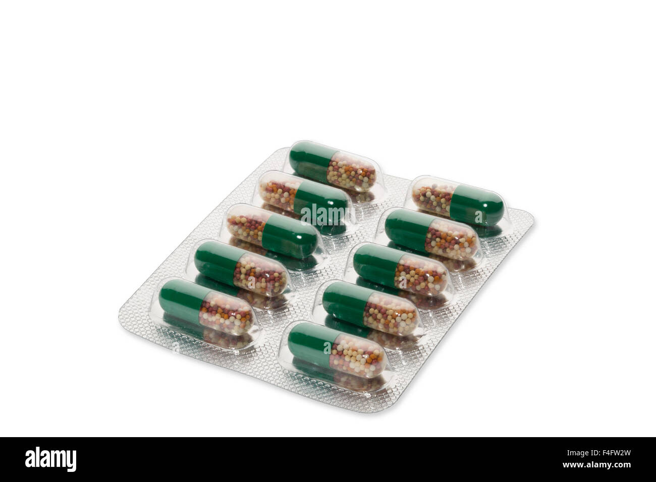 Green pills in a blister package on white background Stock Photo