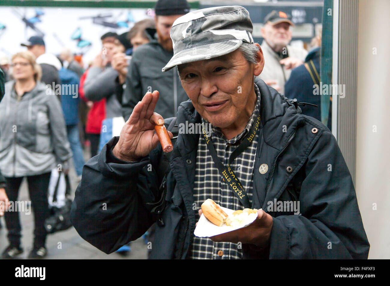 Copenhagen, Denmark, October 17th, 2015. Copenhagen commemorate UN’s “International Day for the Eradication of Poverty” with a grand event forhomeless people with entertainment, food and a cloth fundraising campaign at the Town Hall Square. At the photo a homeless man enjoy a saugae. Credit:  OJPHOTOS/Alamy Live News Stock Photo