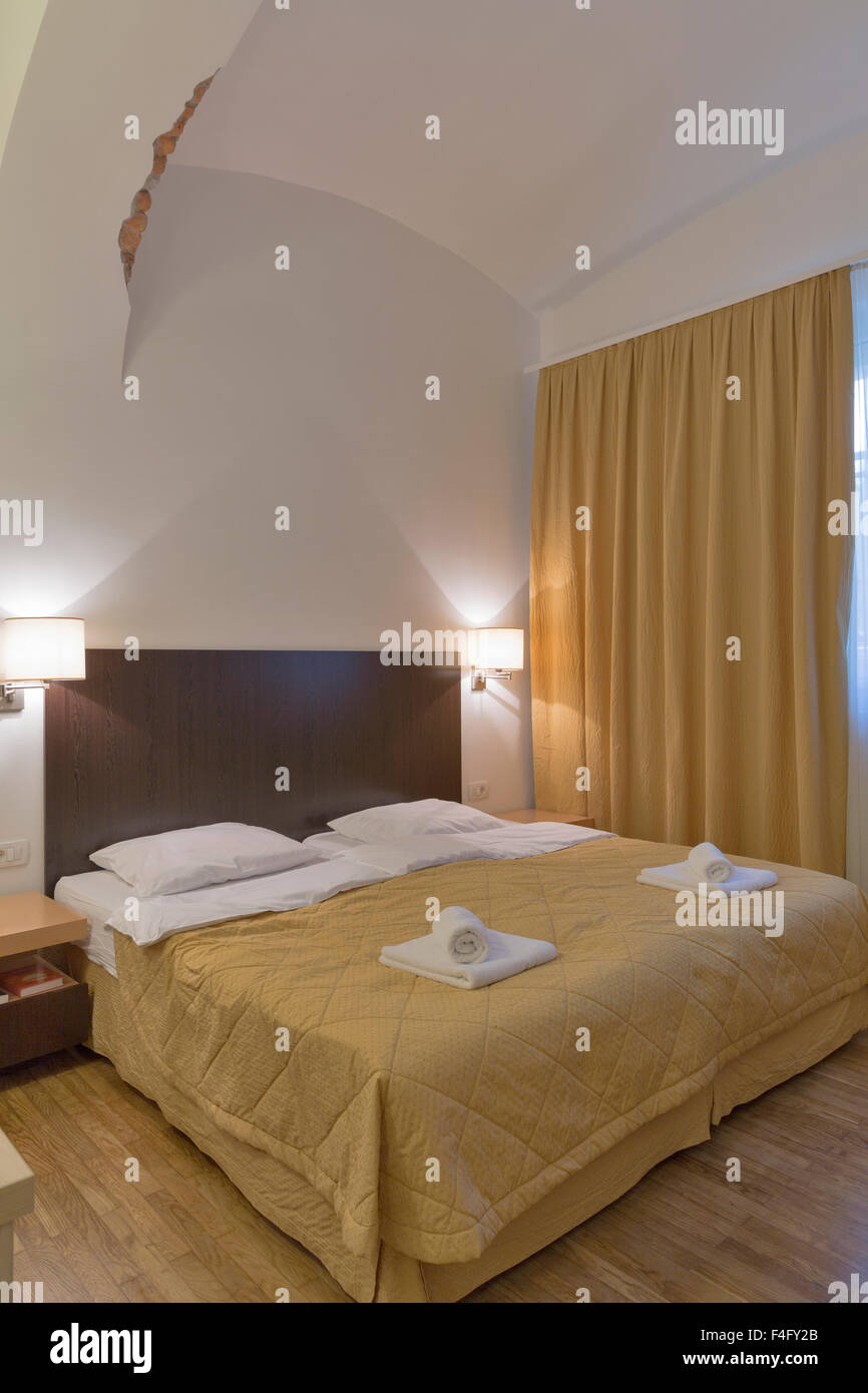 small bedroom with a high ceiling interior Stock Photo