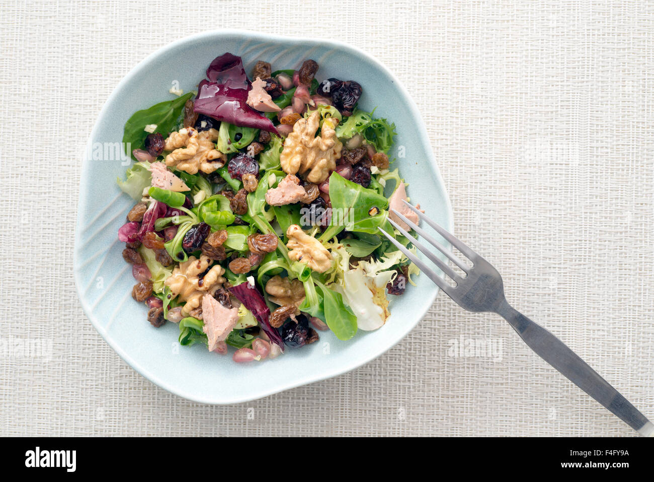 salad with walnuts, raisins, foie gras; blueberries, pomegranate, endive, radicchio and lettuce. Seasoned with olive oil, salt a Stock Photo