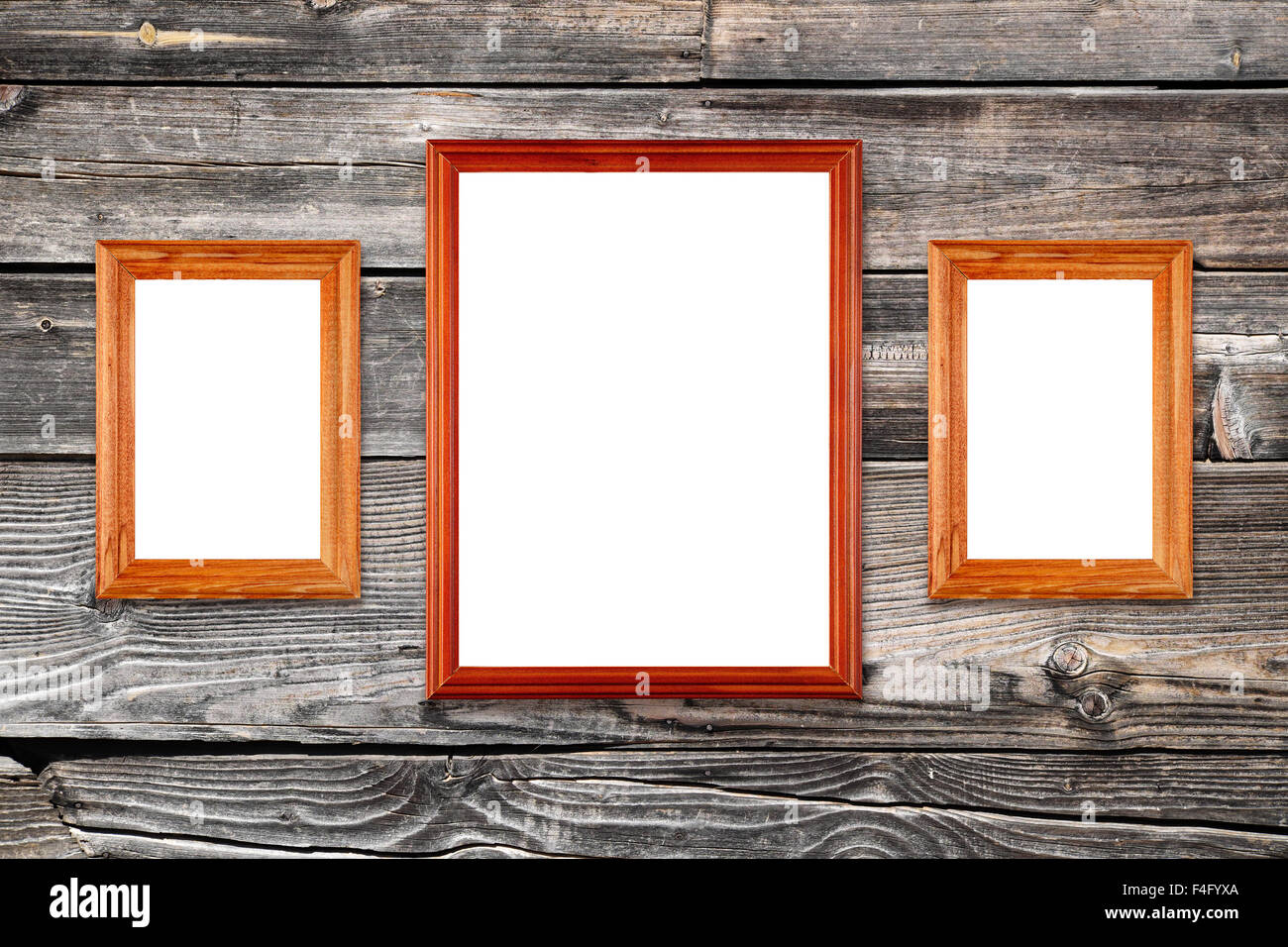 Three empty photo frames on old wooden wall Stock Photo - Alamy