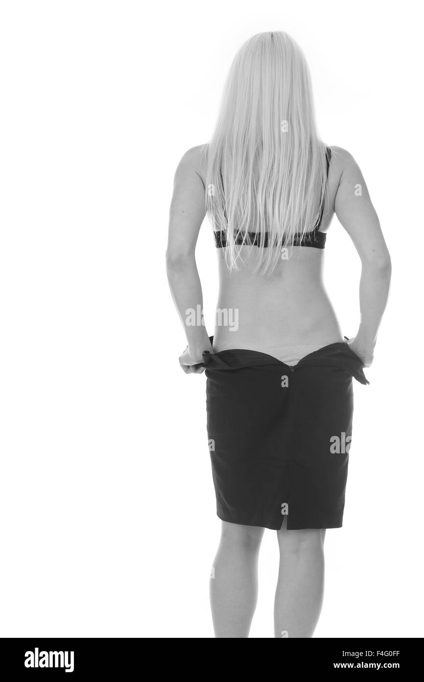 Beautiful young blonde woman taking her skirt off Stock Photo Alamy