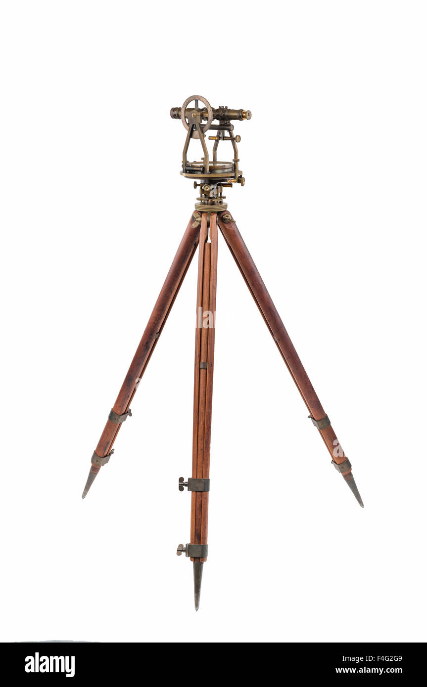 Vintage Surveyor's Level (Transit, Theodolite) with aged Brass Patina  on a Wooden Tripod, focus stacked and isolated on white. Stock Photo