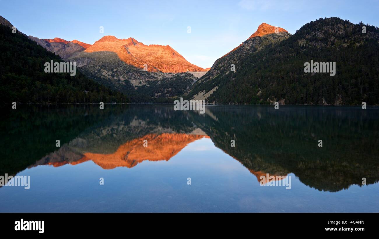 The first light of the day is cast by the rising sun hitting the peaks ...