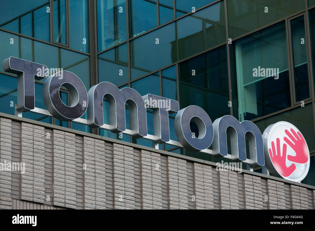 A logo sign outside of the headquarters of TomTom NV in Amsterdam, Netherlands on October 3, 2015. Stock Photo