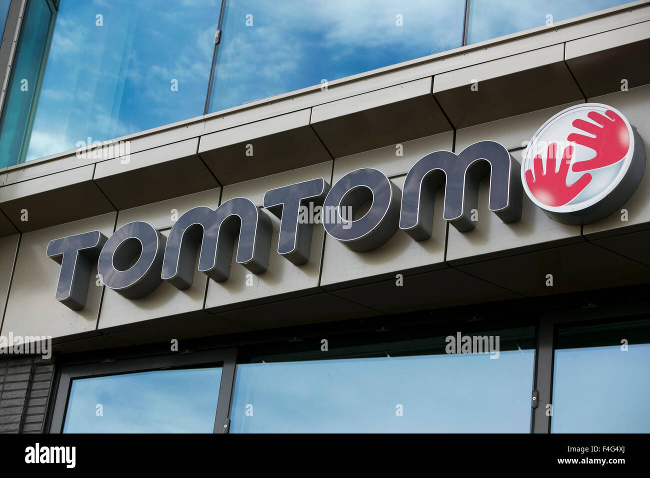 A logo sign outside of the headquarters of TomTom NV in Amsterdam, Netherlands on October 3, 2015. Stock Photo