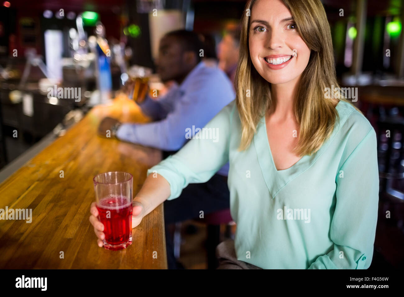 Smiling businesswoman having a drink Stock Photo