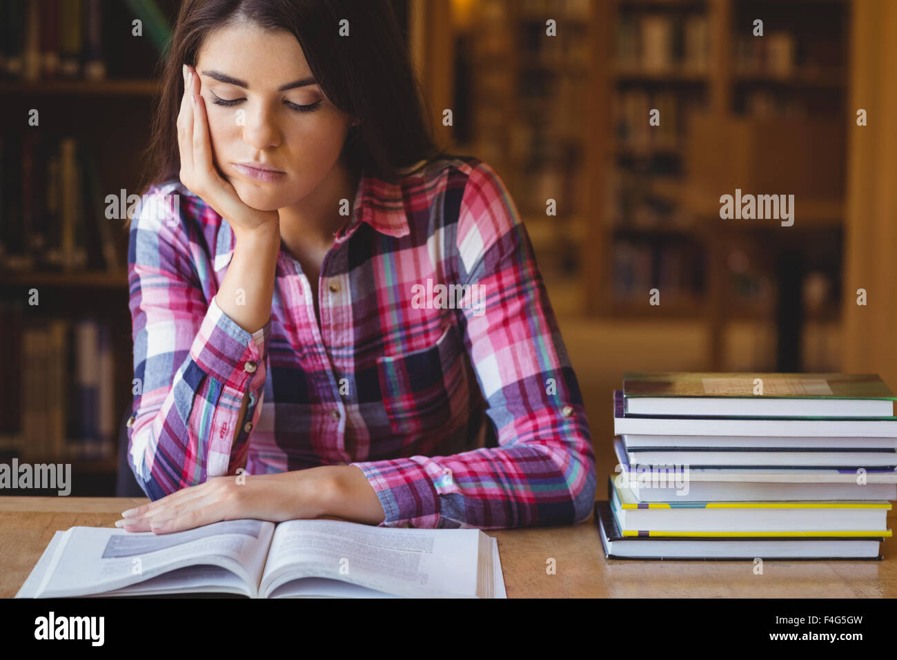 Concentrated female student studying Stock Photo