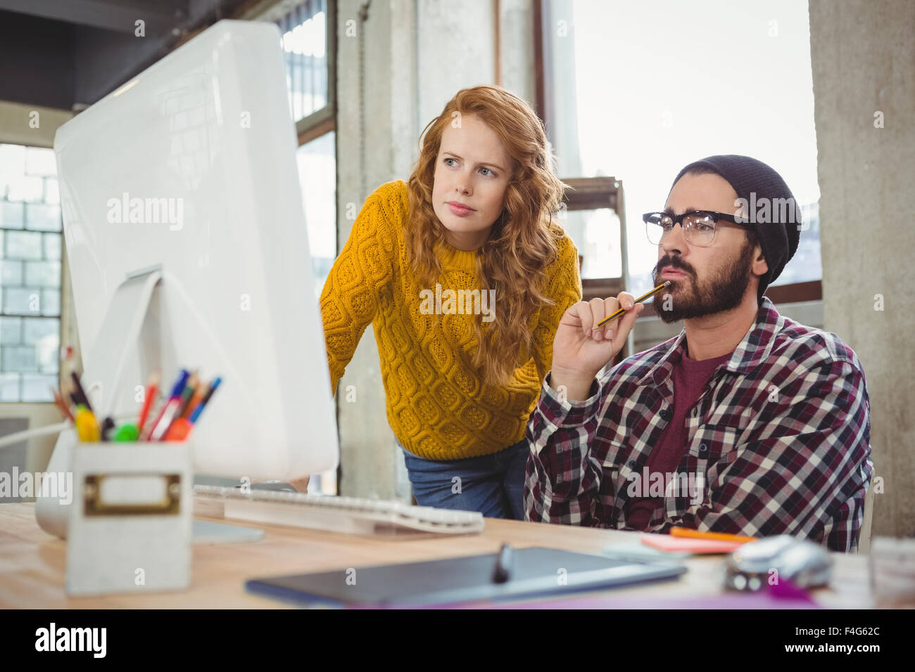 Serious man and woman looking at computer Stock Photo