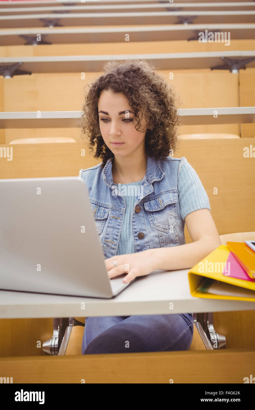Pretty student in lecture hall using laptop Stock Photo - Alamy