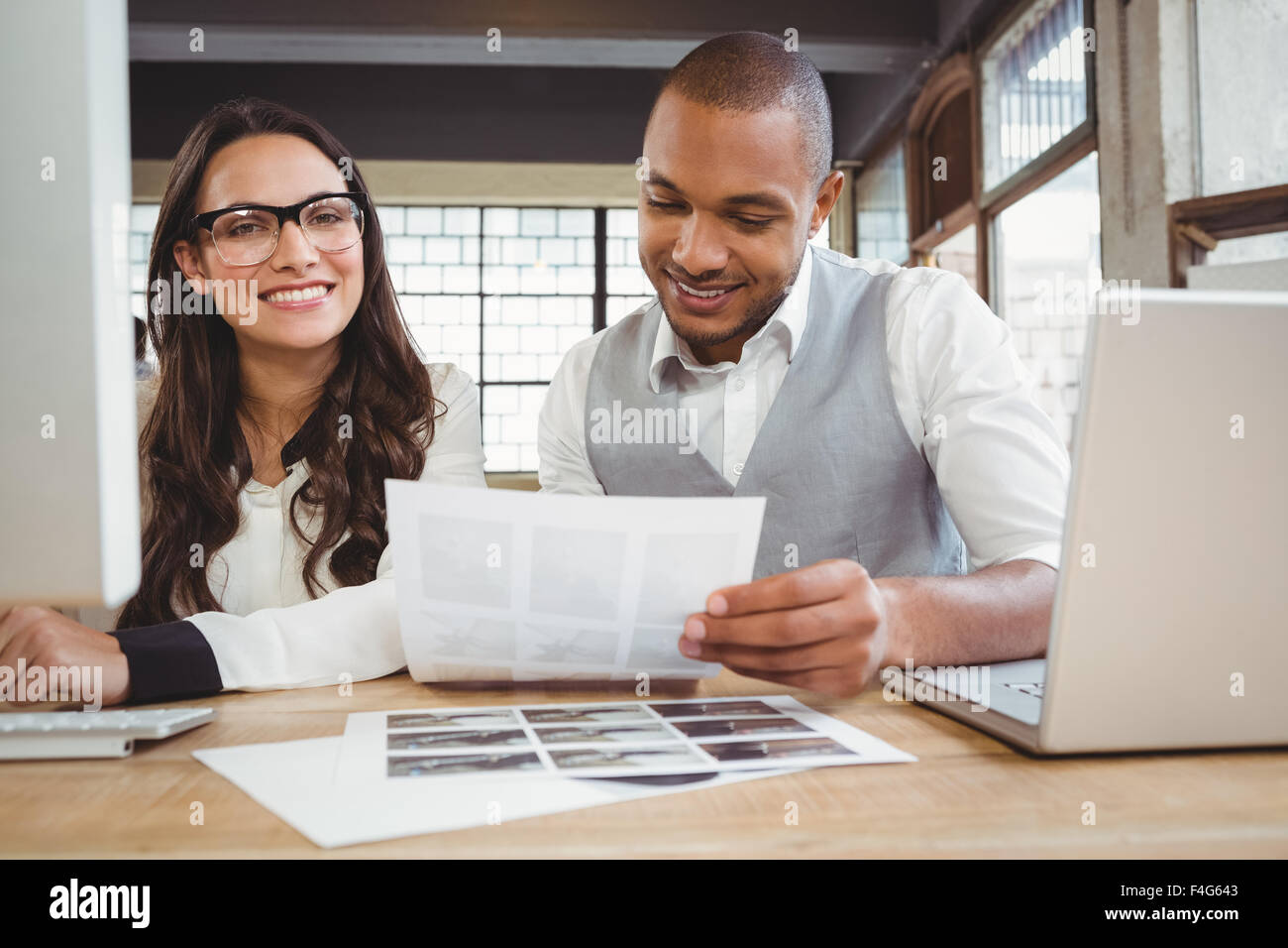 Portrait of woman with working colleague Stock Photo