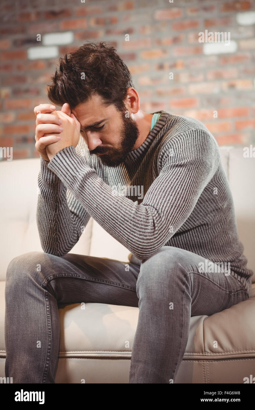 Worried man with hands clasped Stock Photo