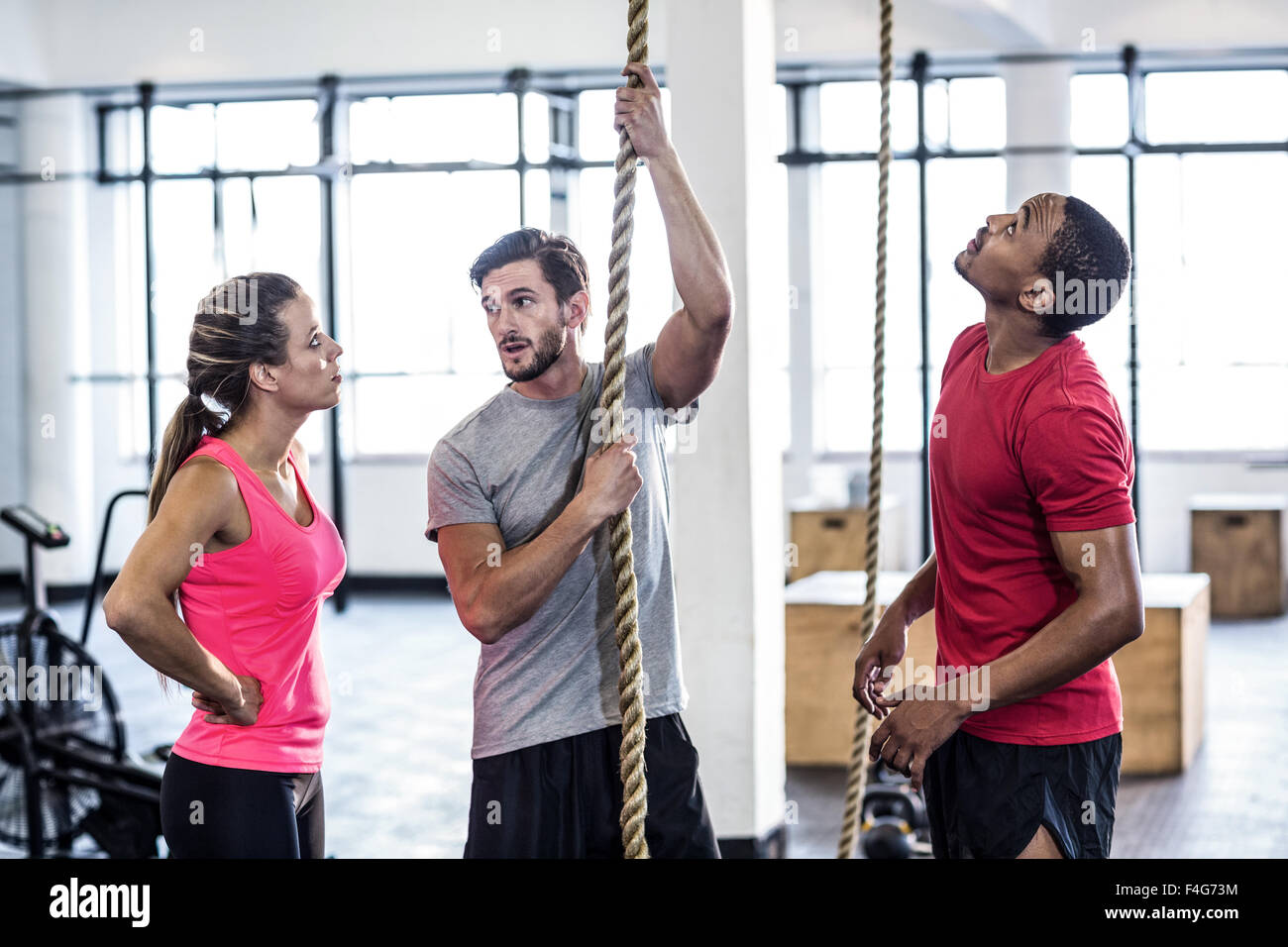 Man with trainers climbing ropes Stock Photo