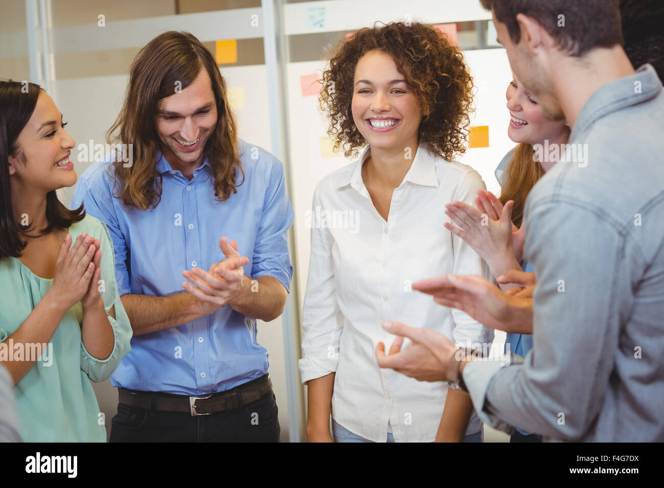 Business people applauding in office Stock Photo