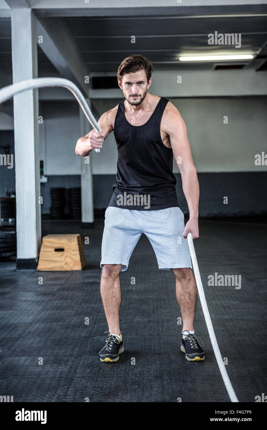 Fit man working out with battle ropes Stock Photo
