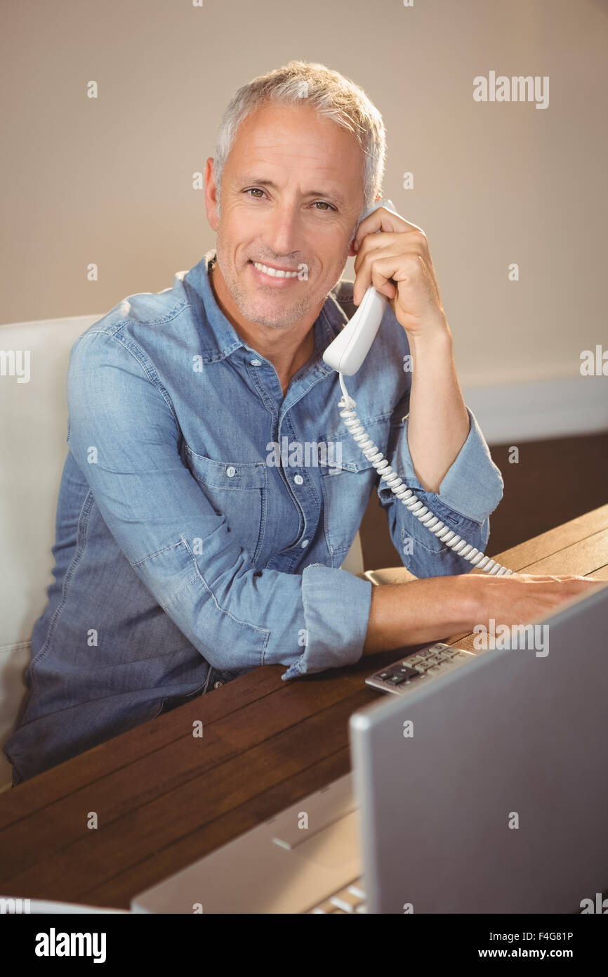 Portrait of creative businessman with telephone Stock Photo