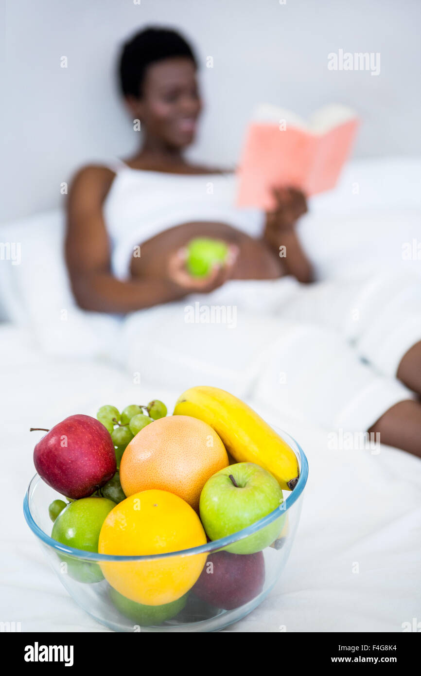Pregnant woman holding apple in hand Stock Photo