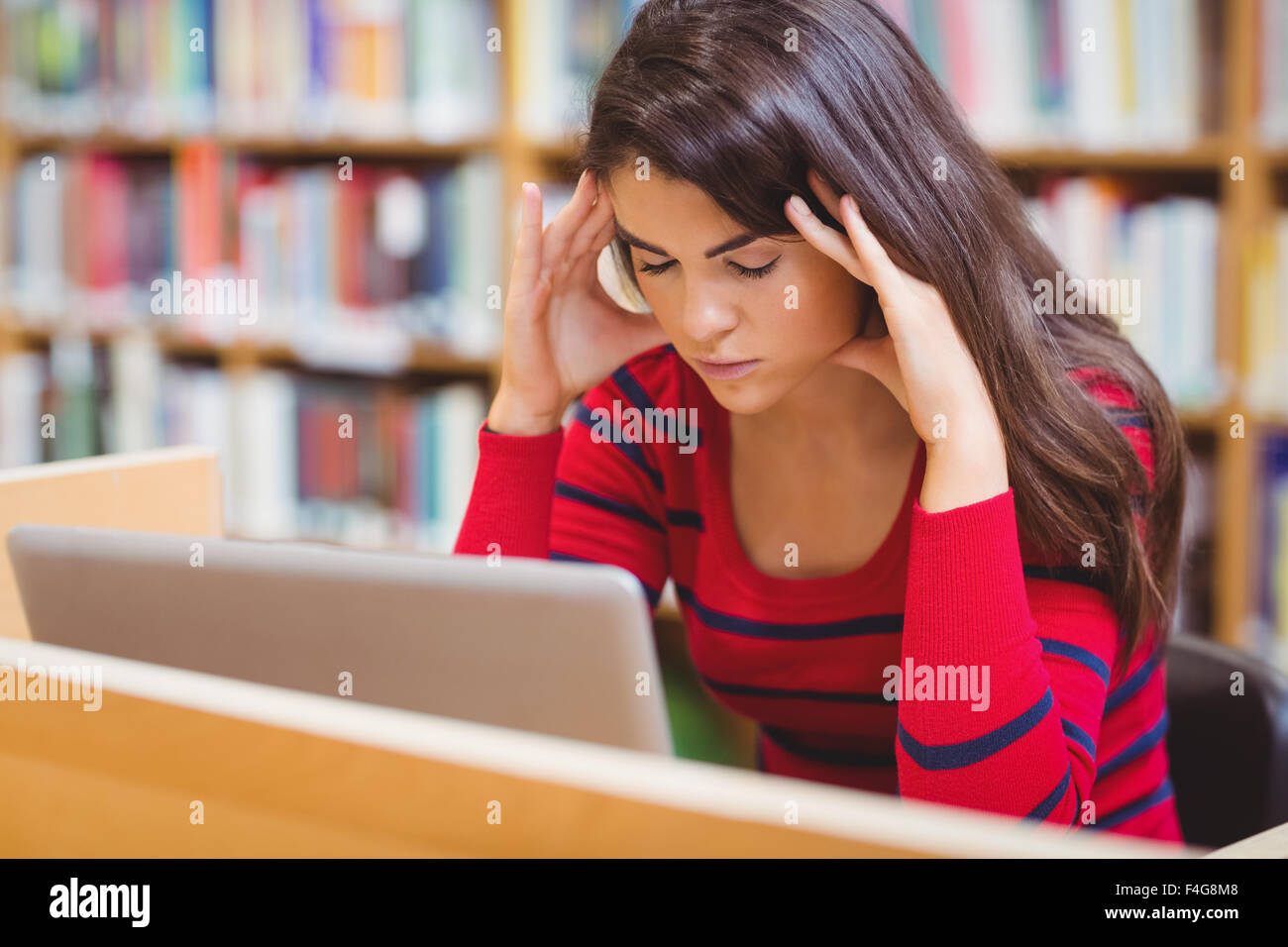 Worried student suffering from headache Stock Photo
