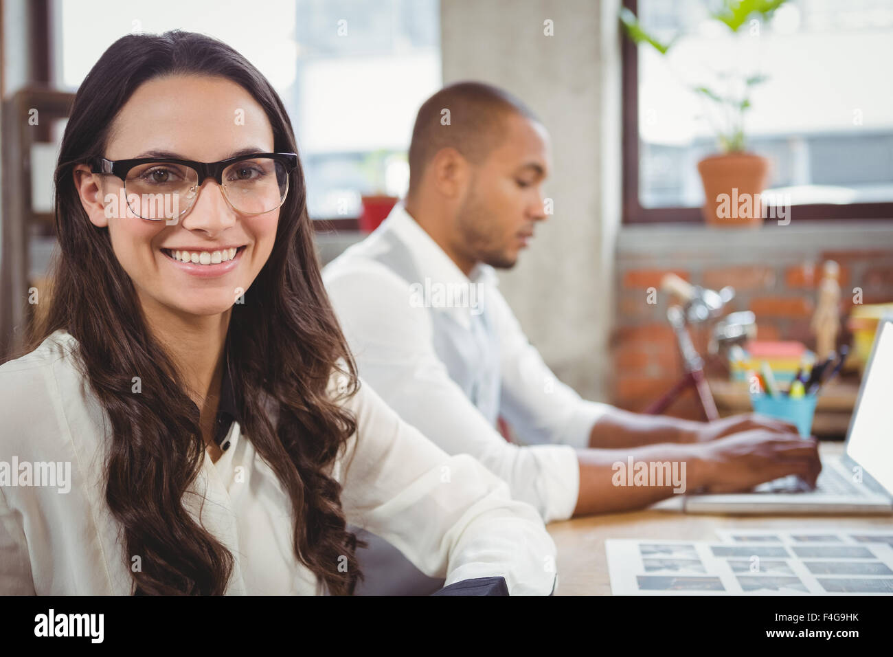 Businesswoman smiling at office Stock Photo