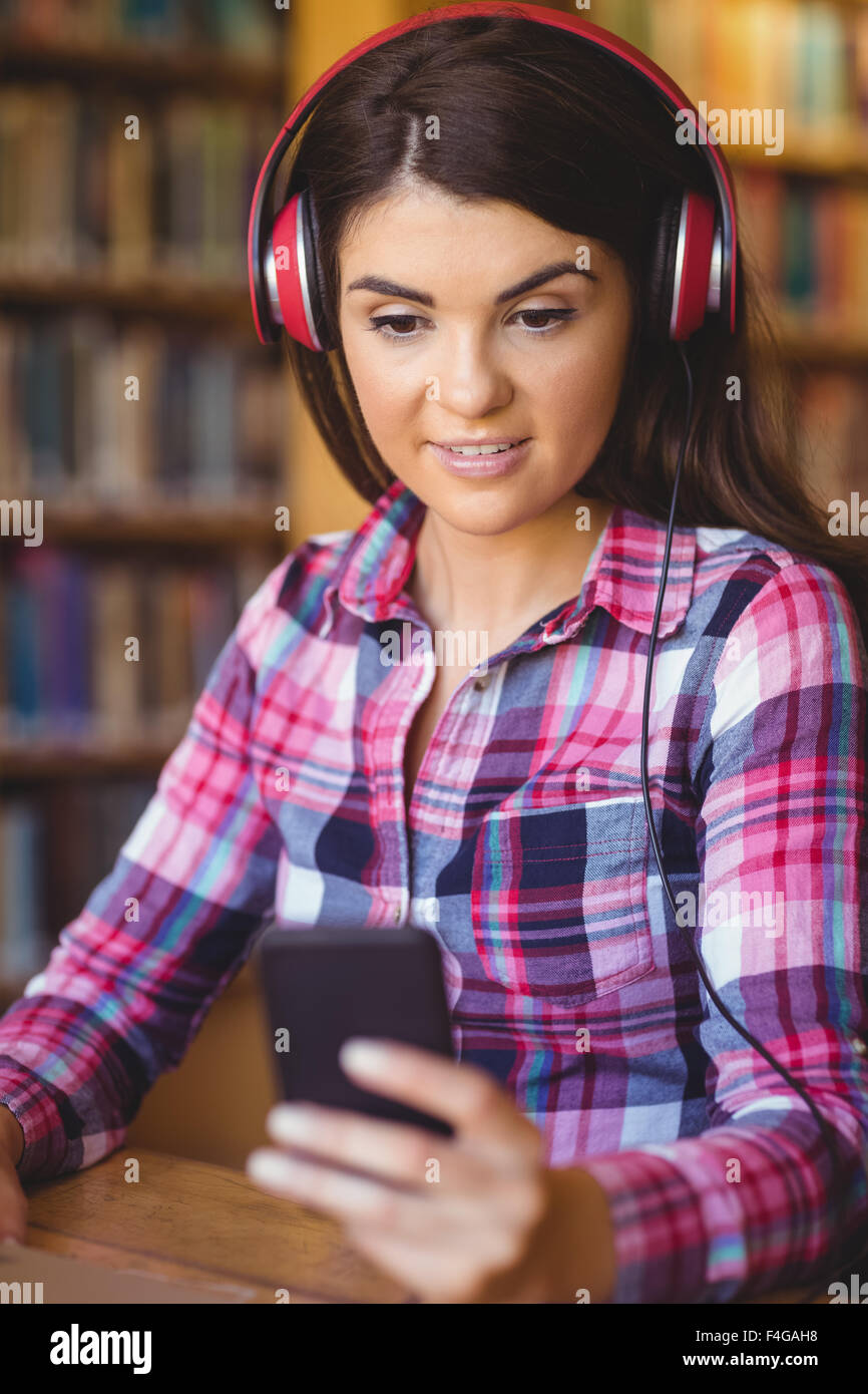 Female student listening music on headphones Stock Photo