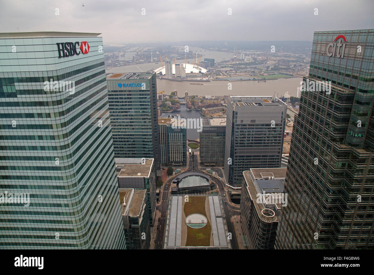 Aerial view of Canary Wharf with HSBC, Citibank, and Barclays buildings all prominent and the O2 arena across the River Thames. Stock Photo